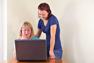 Two people looking at a laptop