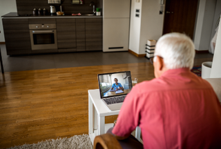 Man using laptop for a virtual visit to discuss vital sign monitoring results