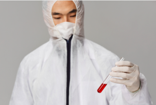 Scientist in a suit analysing a sample of blood