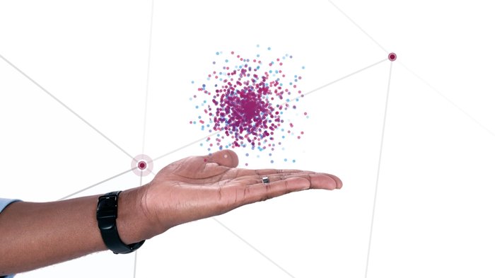 Hand holding coloured dots - UHDA