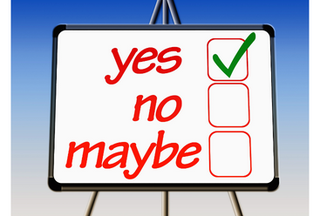 A whiteboard showing a tick box with yes or no options.